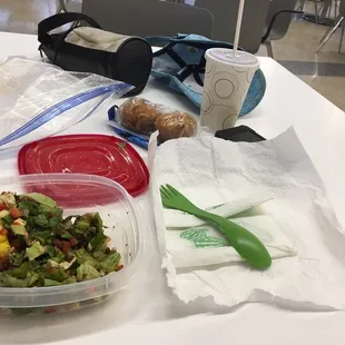 a table with a salad and a cup of coffee