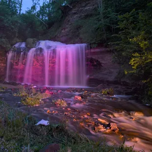 Falls illuminated at dusk.