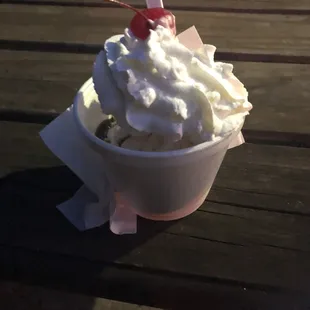 a sundae with whipped cream and a cherry on top