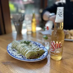 a plate of food and a bottle of beer