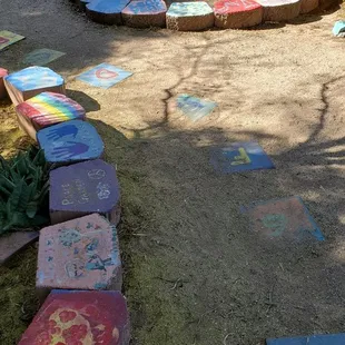 The charming hand-painted rocks and stepping stones of the butterfly garden.