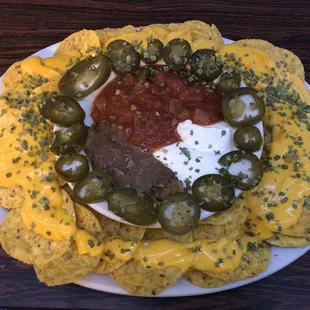 a plate of nachos with beef and cheese