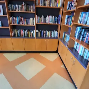a library with bookshelves and a checkered floor