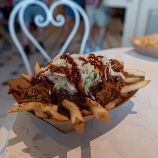 Chipotle Barbecue Loaded Fries topped with Pulled Pork, Slaw, and Chipotle Barbecue Sauce