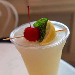 Frozen Mint Julep Lemonade (Plant-based) featuring Minute Maid Premium Lemonade, topped with fresh Mint Leaves, Cherry and Lemon