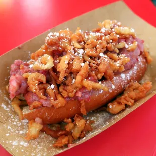 a hot dog covered in toppings