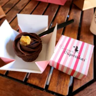a chocolate cupcake with a bite taken out of it