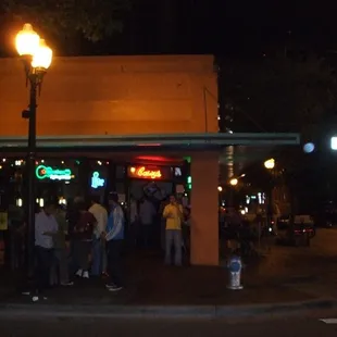 people standing outside of a restaurant