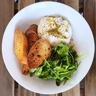 Burrata Salad: Fresh burrata w/ arugula, housemade crostini, extra virgin olive oil, lemon juice, pepper | $17
