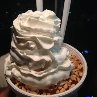 a hand holding a cup of ice cream