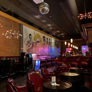 the interior of a bar with red chairs