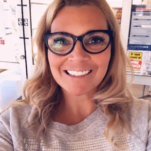 a woman in glasses taking a selfie