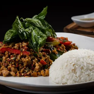Choice of meat stir-fried in garlic chili mix bell peppers, Thai basil, and load of fresh chili for spicy and topped with crispy basil.