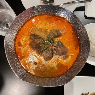 Panang Beef Curry served on a hot plate with candle warmer.
