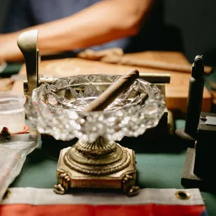 a man working on a cigar