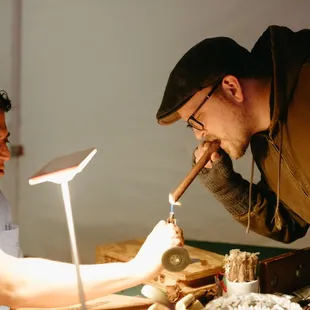 two men smoking cigars
