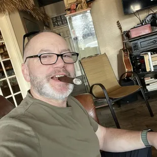 Me enjoying a cigar and chatting staff.