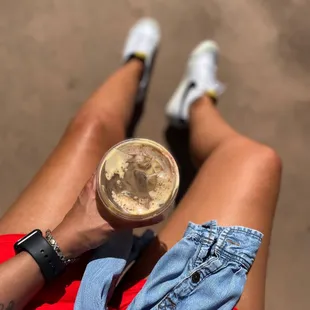 a woman's legs with a glass of coffee