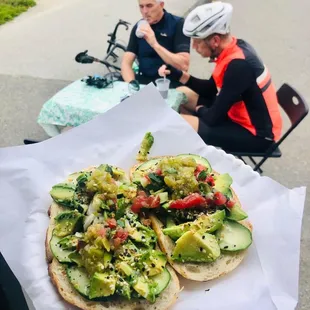 two people sitting at a table with food on it