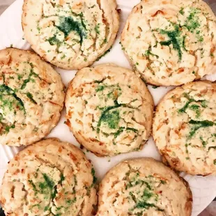 a plate of cookies with cheese and spinach