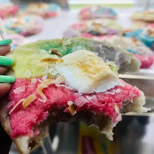 a hand holding a half eaten doughnut