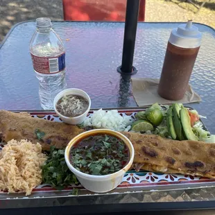Machete (quesobirria) with rice, beans, consommé and all the fixings.