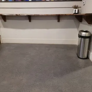a trash can in the corner of a room