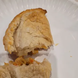 a half eaten pastry on a paper plate
