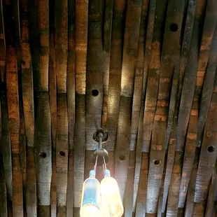 Ceiling panal made of staves from barrels and light fixtures made of bottles