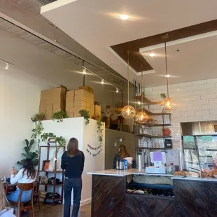a woman standing in a coffee shop