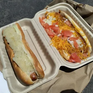 two hot dogs in a styrofoam container