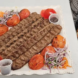 a plate of meat and vegetables on a table