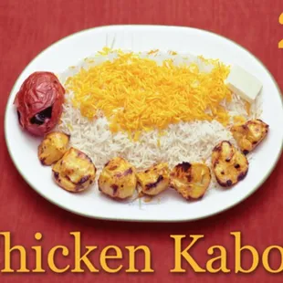 a plate of chicken kabobs and rice