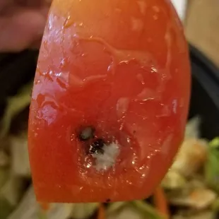 a tomato with a bite taken out of it