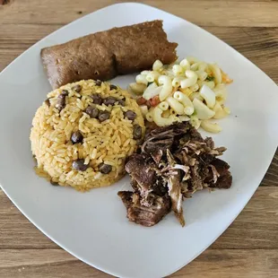 Pastel, pernil, arroz con gandules, and coditos.