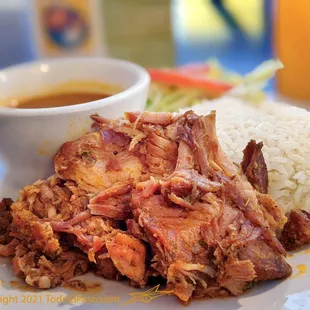 a plate of food with rice and meat