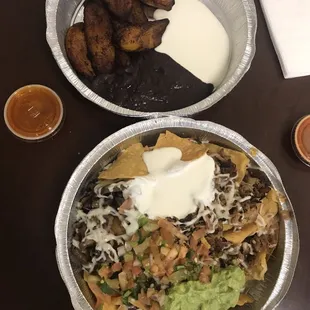 Plaintains and super nachos with carne asada and carnitas