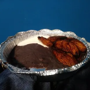 Platanos fritos (fried plantains) with black beans and cream