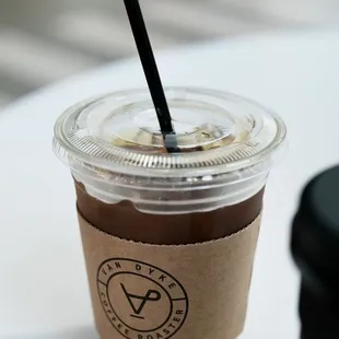 a cup of coffee with a straw