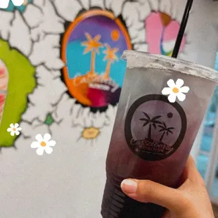 a hand holding a drink