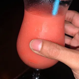 a hand holding a drink