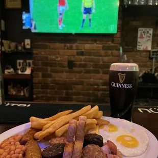 a plate of food and a glass of beer