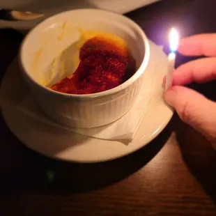 Creme brule with candle.