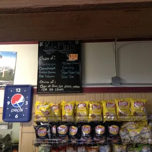 From the cashier's back view with potato chips and the kids menu.