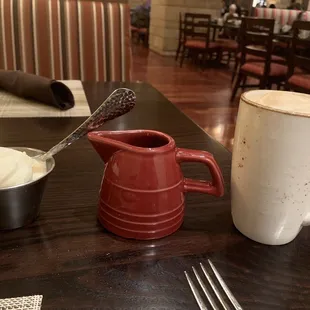 Whipped cream, cup for hazelnut syrup and latte.