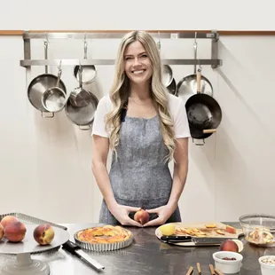 a woman standing in a kitchen