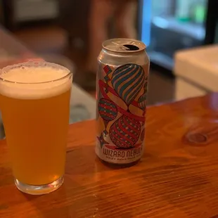 a glass of beer and a can of beer