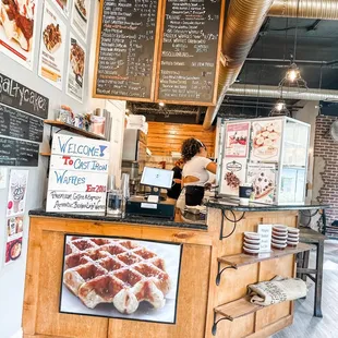 a woman standing behind the counter