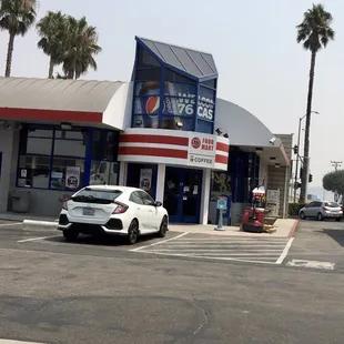 a car parked in front of a pepsi store