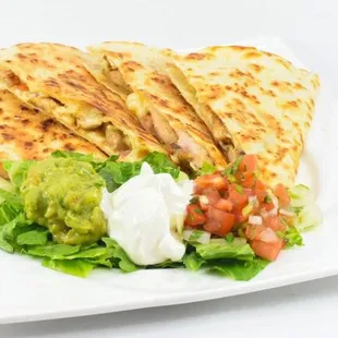 a plate of food with quesadillas and guacamole